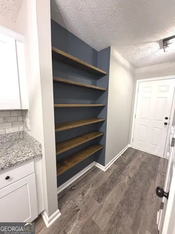 a view of walk in closet with empty racks