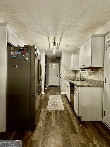 a kitchen with refrigerator and window