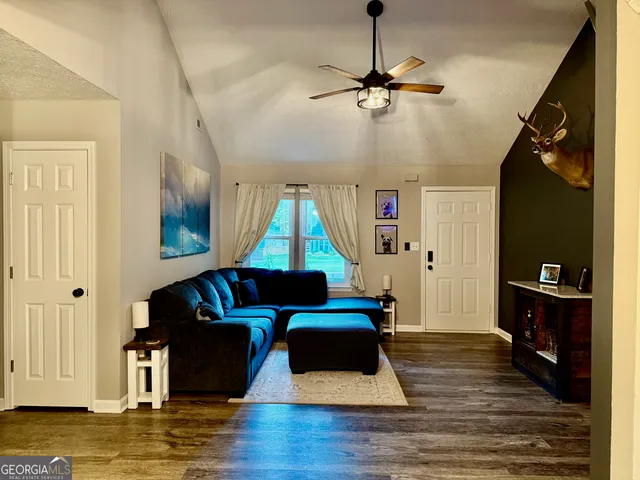 a living room with furniture and a wooden floor
