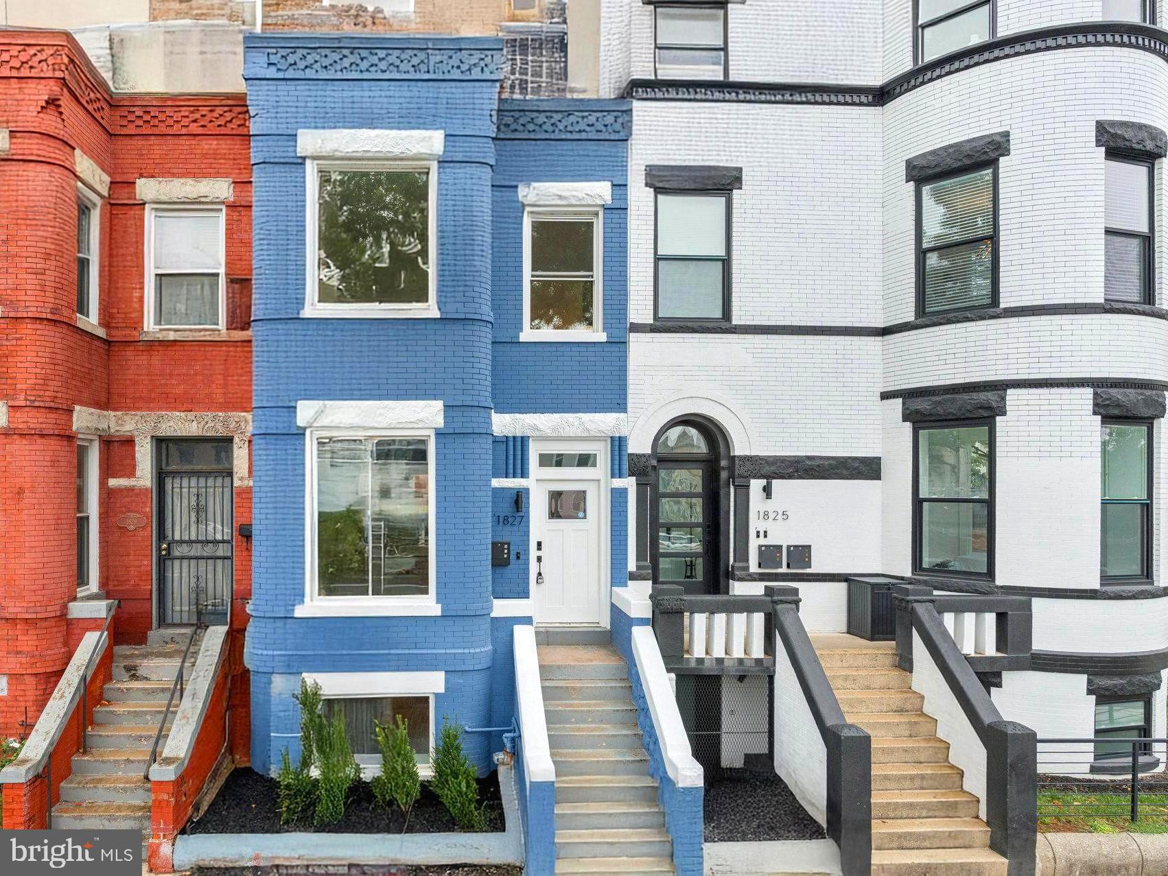 a front view of a residential apartment building with a yard