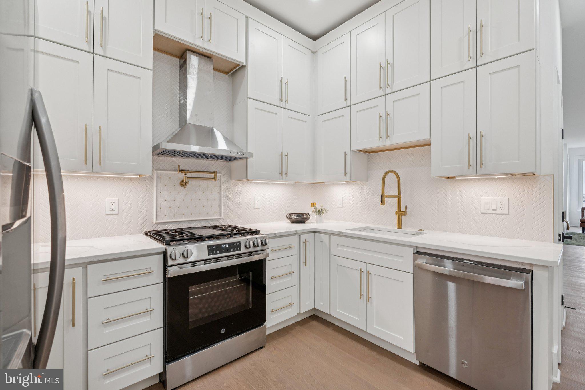 1827 North Capitol Street Northeast Washington, DC 20002 - Photo 13 of 53 a kitchen with white cabinets and white appliances