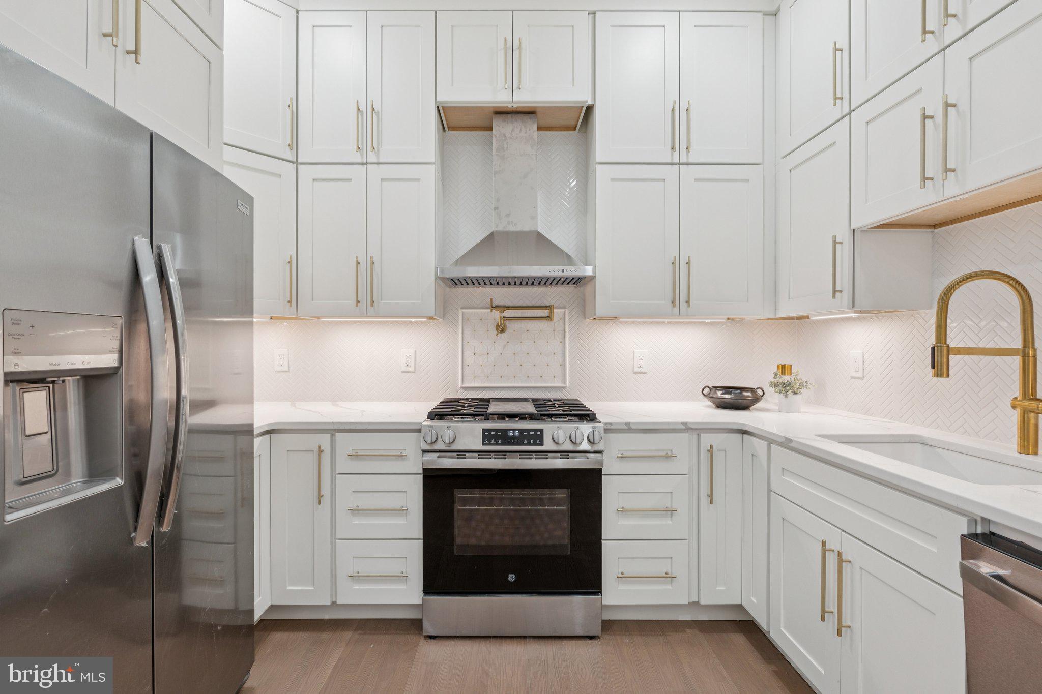 1827 North Capitol Street Northeast Washington, DC 20002 - Photo 14 of 53 a kitchen with stainless steel appliances granite countertop white cabinets and a stove
