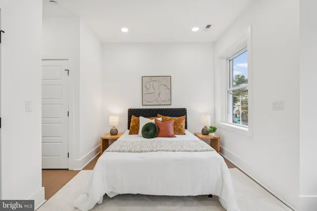a bedroom with a large bed and a window