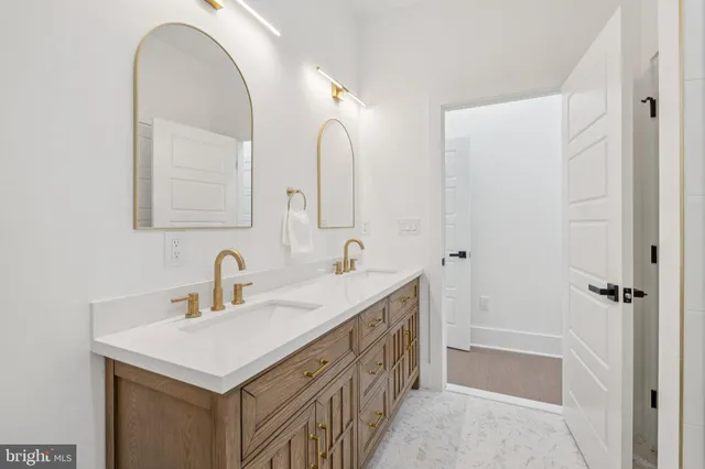 a bathroom with a double vanity sink and a mirror