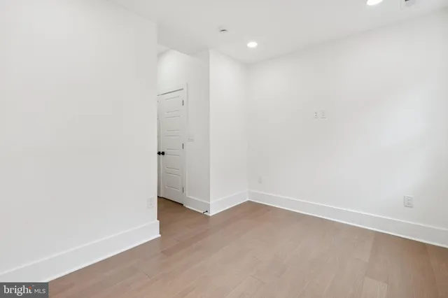 an empty room with wooden floor