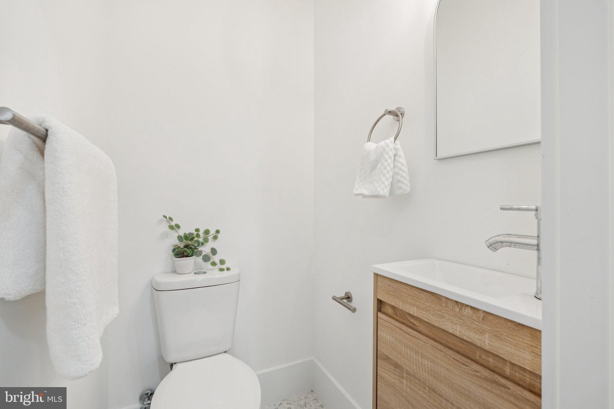 1827 North Capitol Street Northeast Washington, DC 20002 - Photo 34 of 53 a bathroom with a toilet sink and mirror