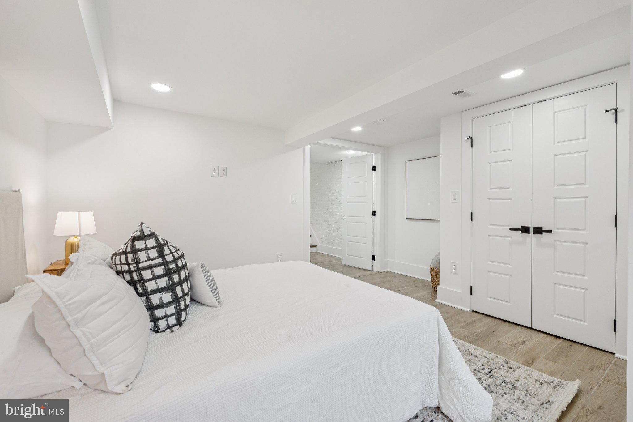 1827 North Capitol Street Northeast Washington, DC 20002 - Photo 40 of 53 a bedroom with a bed and a chandelier