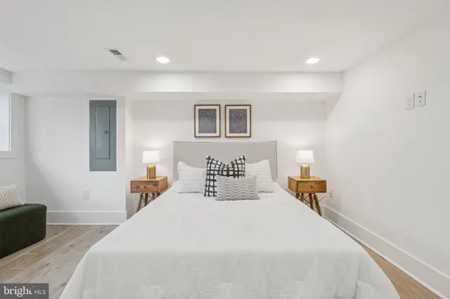 a bathroom with a toilet a sink a mirror and vanity