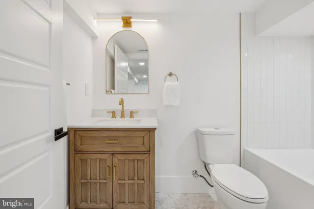 a bathroom with a bathtub and a toilet