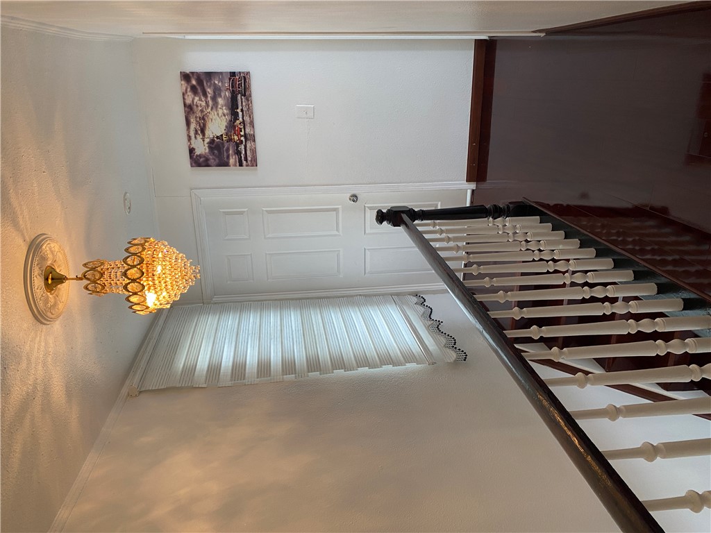 175 Rita Street Dayton, OH 45404 - Photo 28 of 48 Elegant staircase with polished hardwood floors and a striking crystal light fixture.