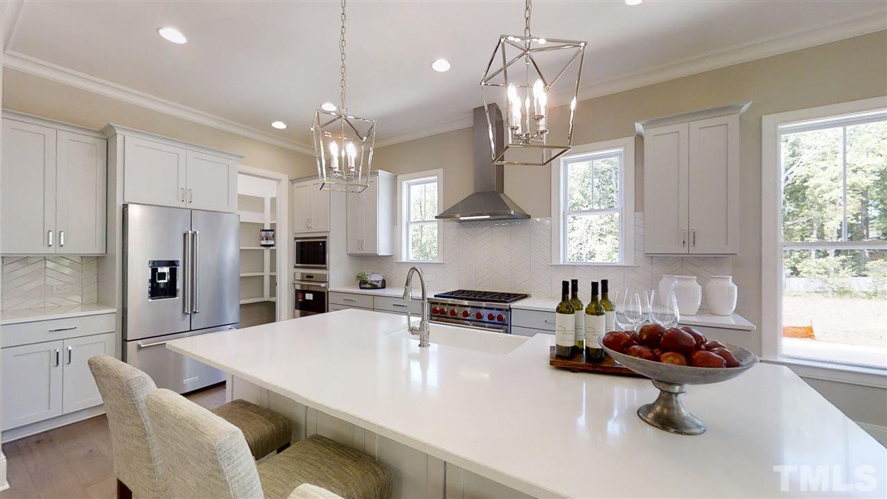 3036 Eden Harbor Court Raleigh, NC 27613 - Photo 3 of 22 Quartz Island with Wolf appliances. Kitchenaid refrigerator.