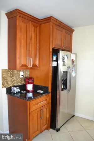 a kitchen with stainless steel appliances granite countertop a refrigerator and a stove