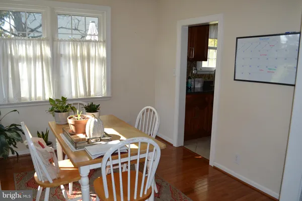 a view of a dining room with furniture and window
