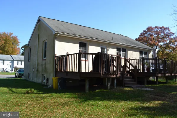 a front view of house with a garden