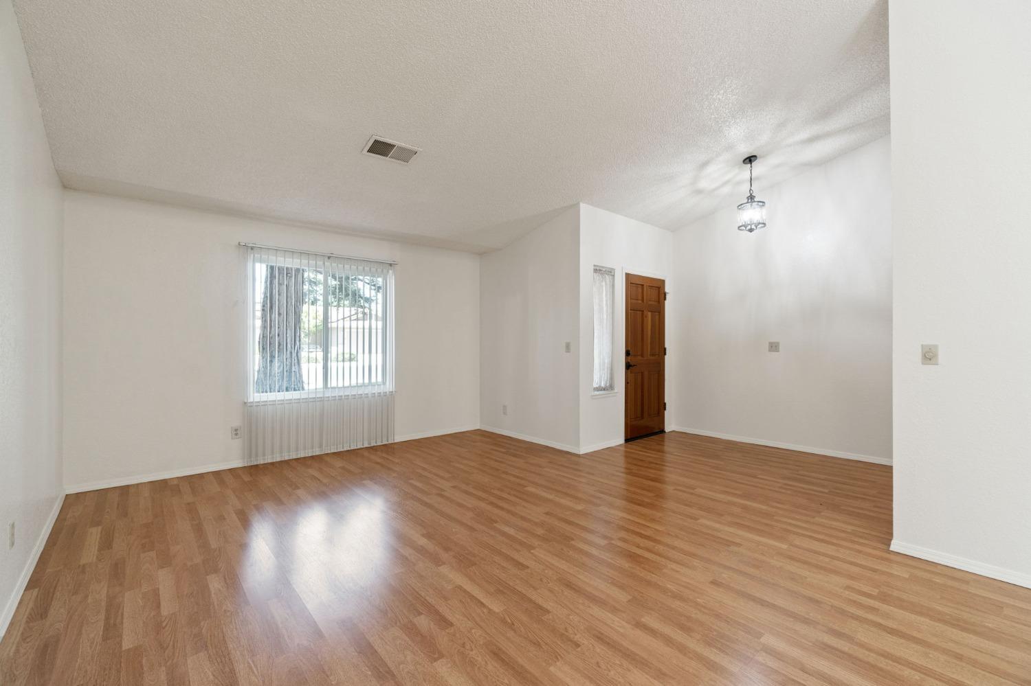 2500 Mitchell Avenue Clovis, CA 93611 - Photo 12 of 31 an empty room with wooden floor and windows