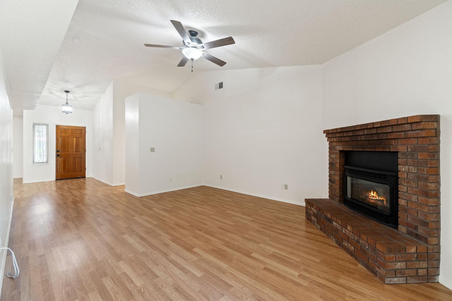 2500 Mitchell Avenue Clovis, CA 93611 - Photo 17 of 31 a view of empty room with wooden floor and fireplace