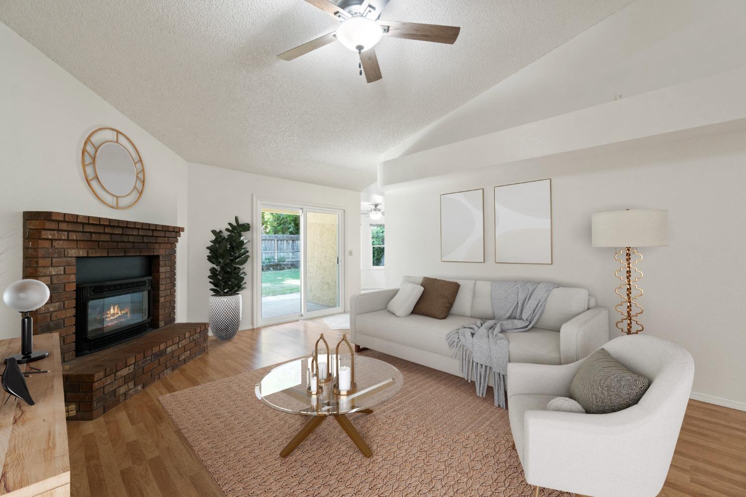 2500 Mitchell Avenue Clovis, CA 93611 - Photo 2 of 31 a living room with furniture a fireplace a rug and a window