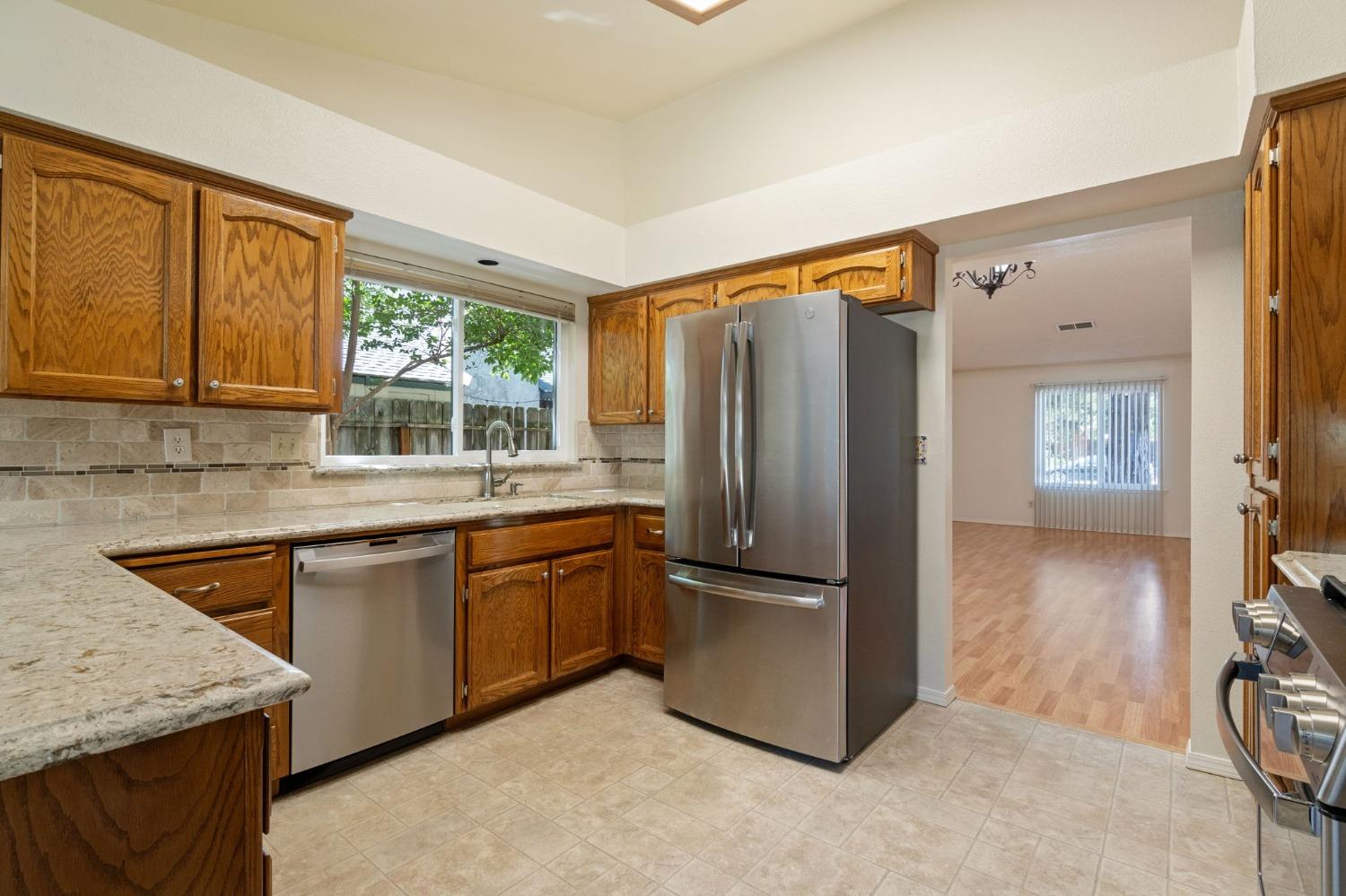 2500 Mitchell Avenue Clovis, CA 93611 - Photo 4 of 31 a kitchen with stainless steel appliances granite countertop a refrigerator and a sink