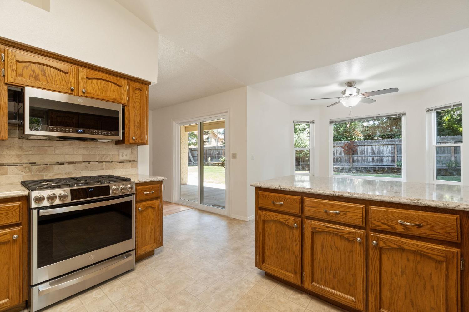 2500 Mitchell Avenue Clovis, CA 93611 - Photo 5 of 31 a kitchen with granite countertop cabinets stainless steel appliances and a window