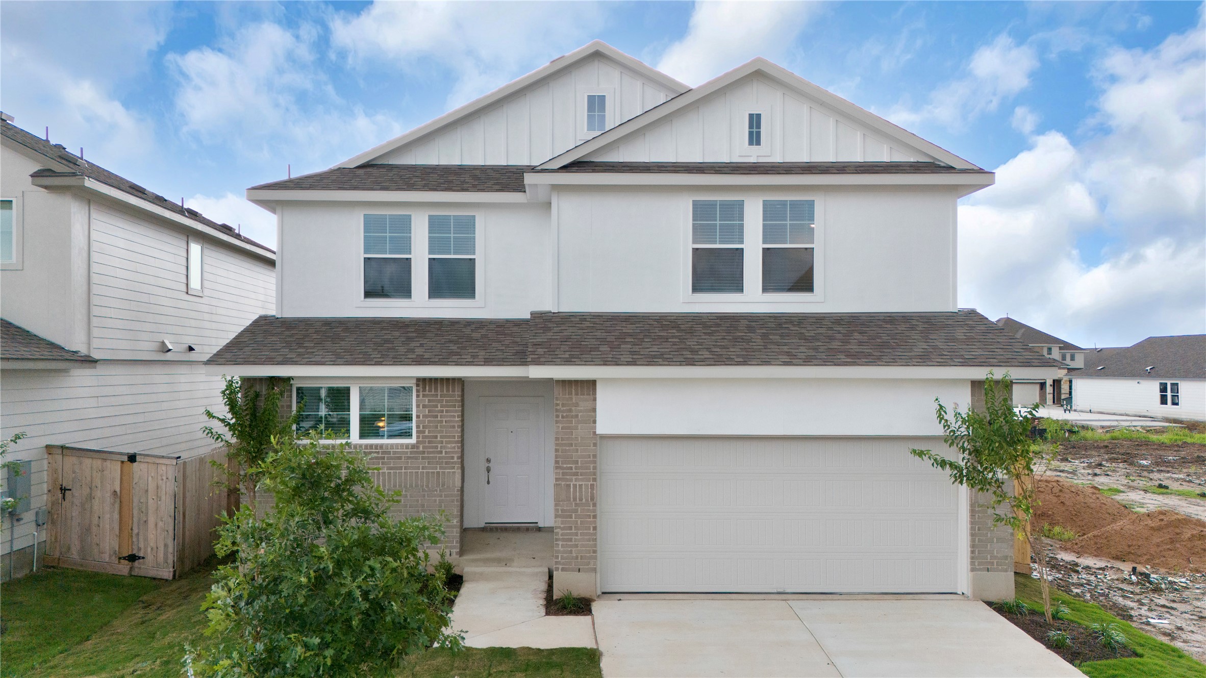 25612 Wheat Seed Lane Elgin, TX 78621 - Photo 7 of 26 a front view of a house with a yard and garage