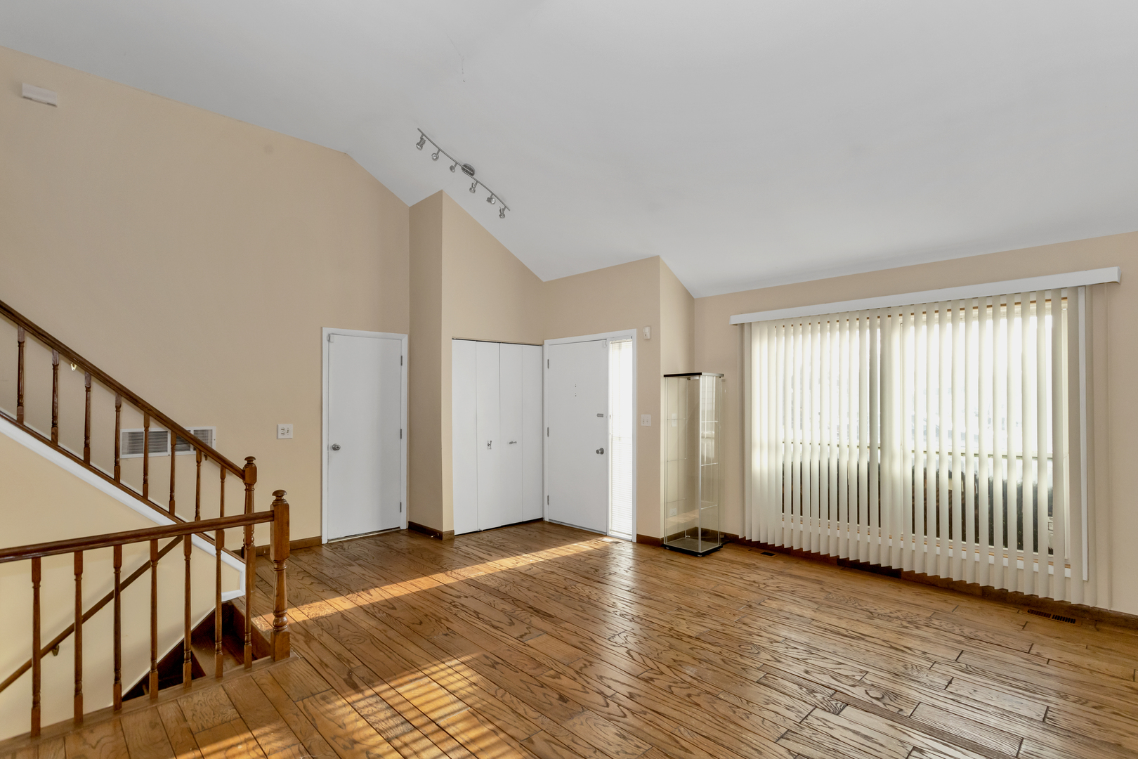 664 Claridge Circle Hoffman Estates, IL 60169 - Photo 11 of 35 a view of a livingroom with wooden floor and stairs