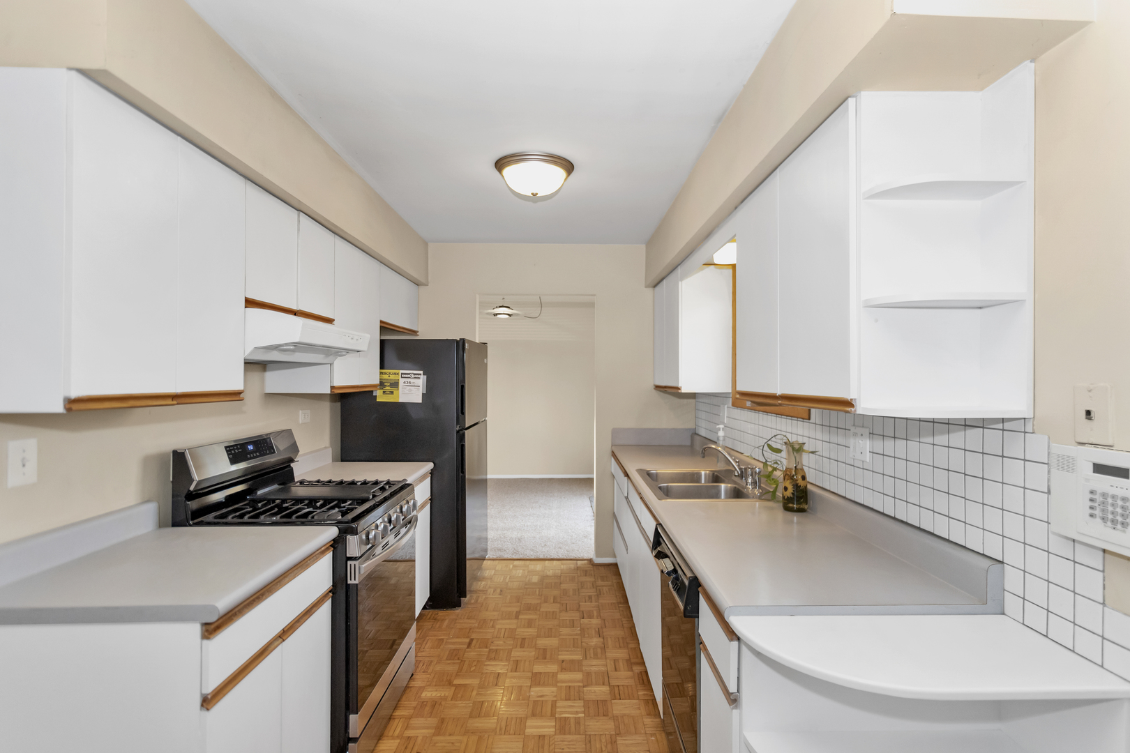 664 Claridge Circle Hoffman Estates, IL 60169 - Photo 14 of 35 a kitchen with stainless steel appliances granite countertop a sink stove and refrigerator