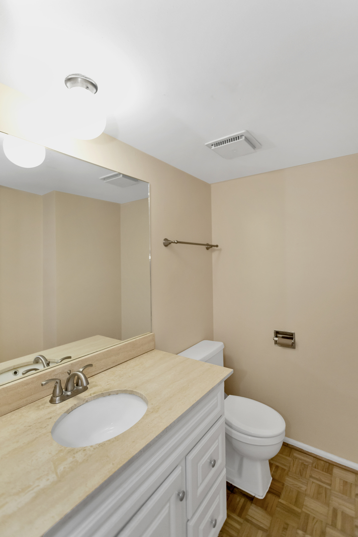 664 Claridge Circle Hoffman Estates, IL 60169 - Photo 29 of 35 a bathroom with a granite countertop sink a toilet and a mirror