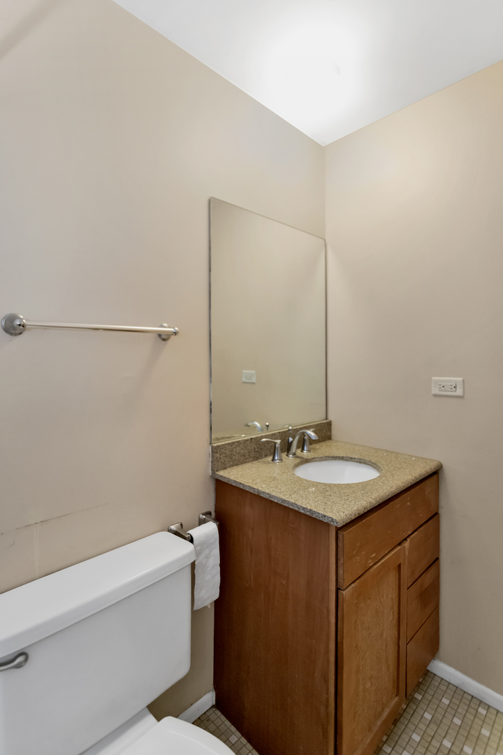 664 Claridge Circle Hoffman Estates, IL 60169 - Photo 31 of 35 a bathroom with a granite countertop sink a toilet mirror and bathtub