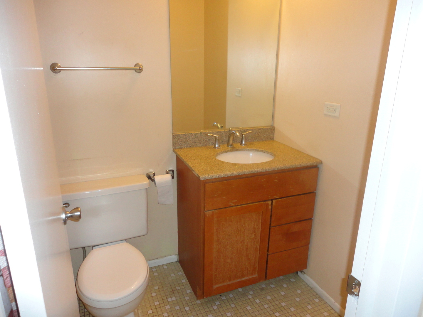 664 Claridge Circle Hoffman Estates, IL 60169 - Photo 33 of 35 a bathroom with a toilet sink vanity and mirror