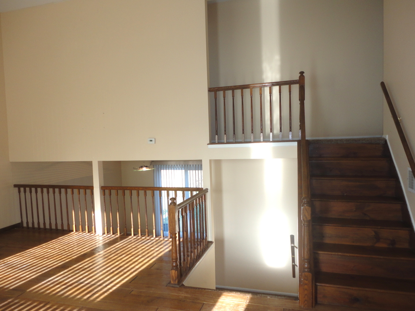664 Claridge Circle Hoffman Estates, IL 60169 - Photo 7 of 35 a view of a hallway with wooden floor and staircase