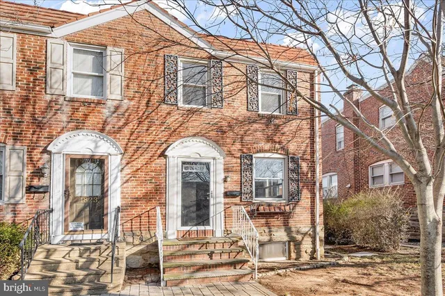 front view of a brick house with a fountain