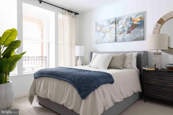 a bedroom with a bed and a large window