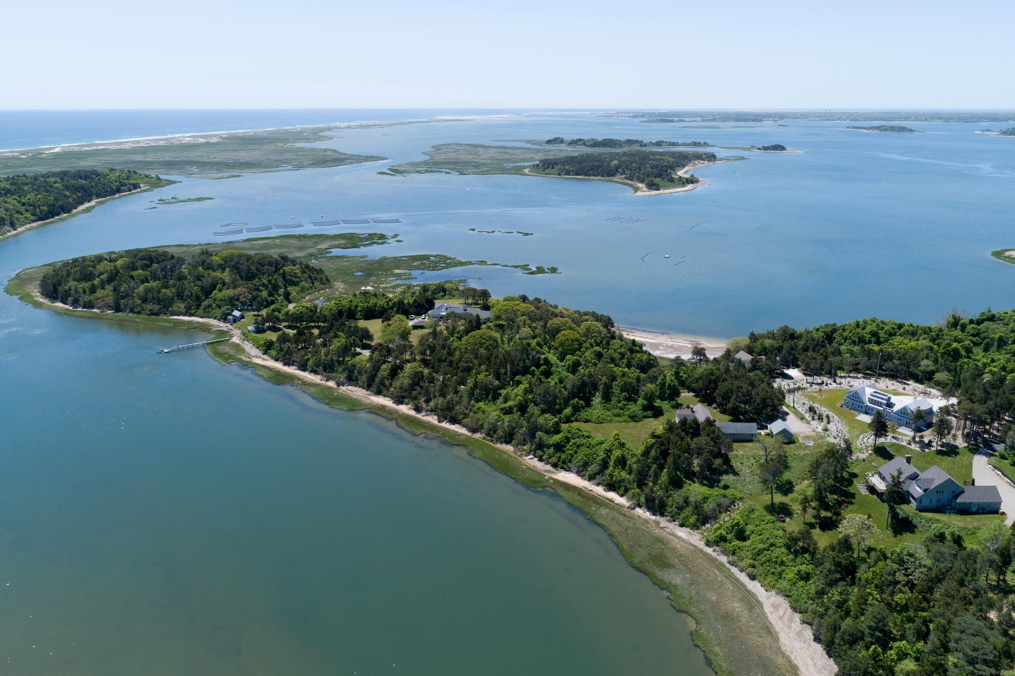 an aerial view of lake and residential houses with outdoor space
