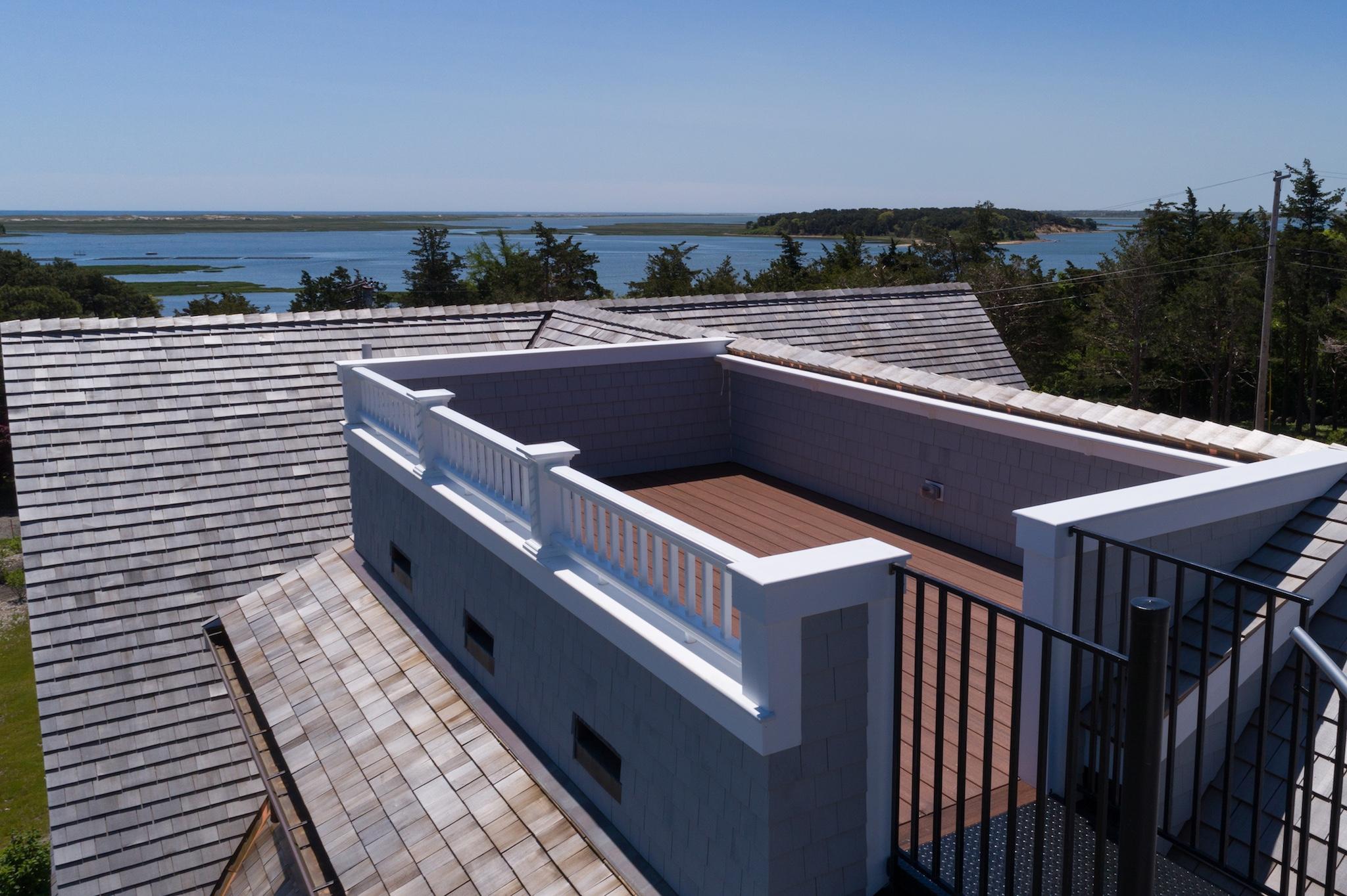 43 Payson Lane Orleans, MA 02653 - Photo 16 of 34 a view of a roof deck with couches and wooden floor