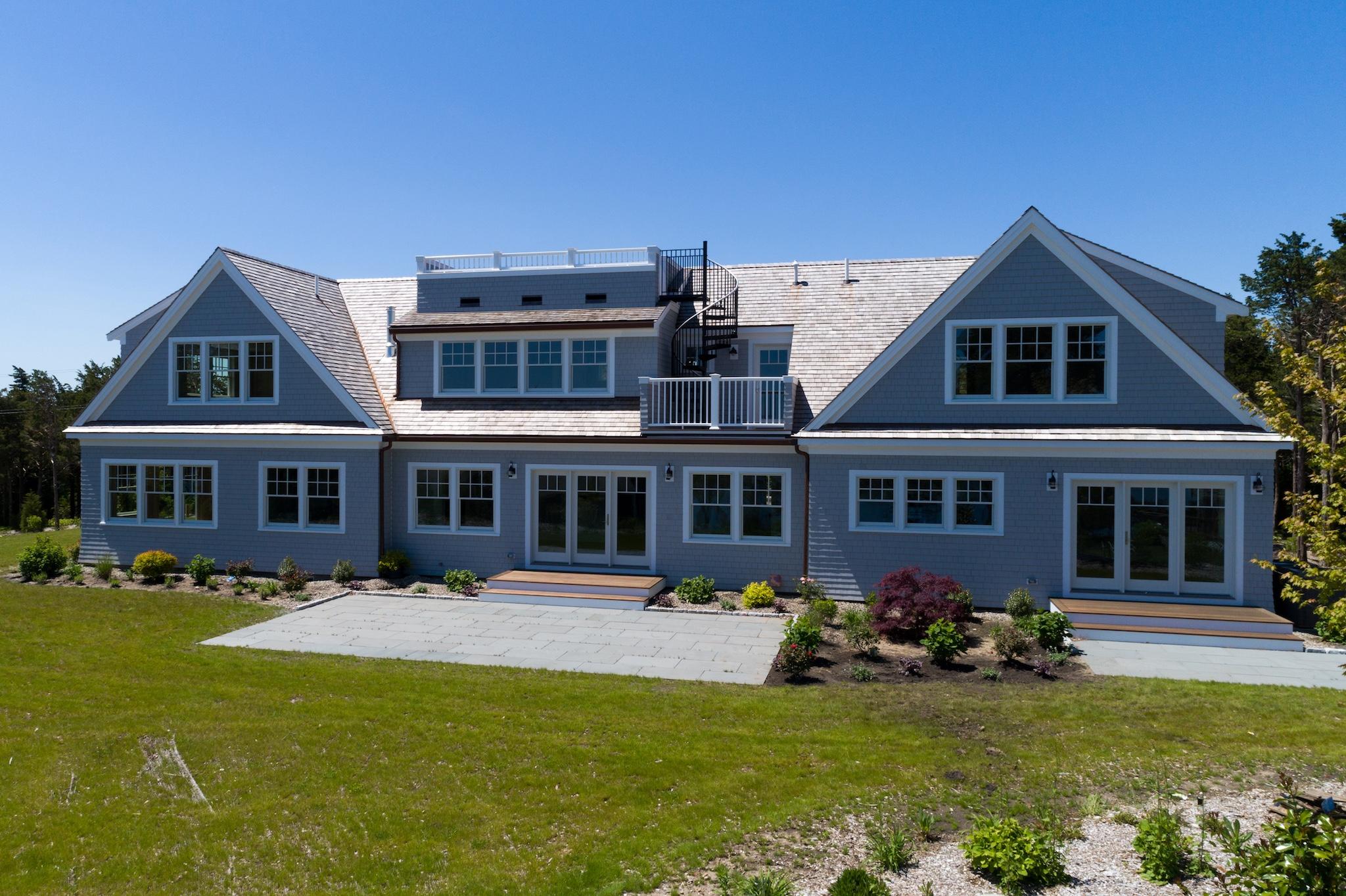 43 Payson Lane Orleans, MA 02653 - Photo 29 of 34 a front view of a house with a yard table and chairs