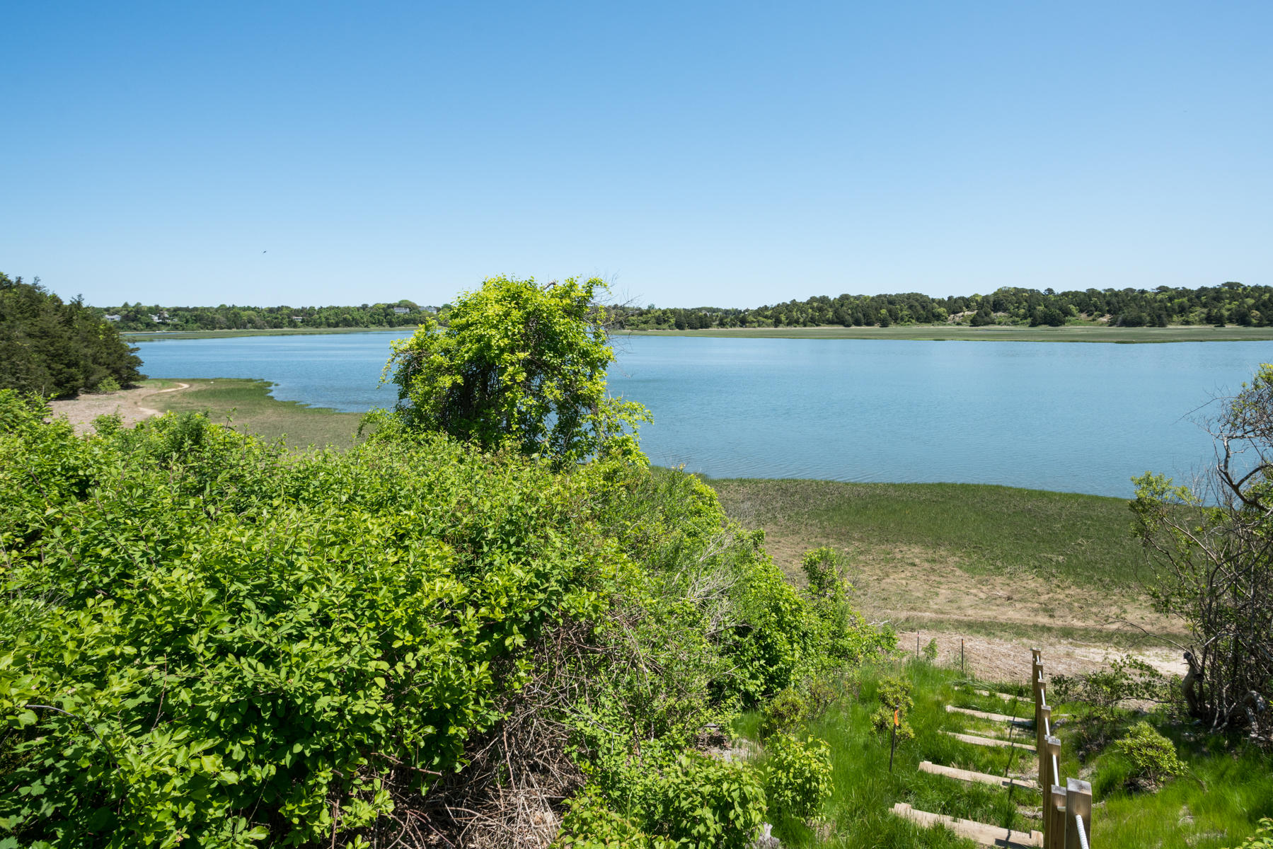 43 Payson Lane Orleans, MA 02653 - Photo 4 of 34 a view of a lake with a house in the background