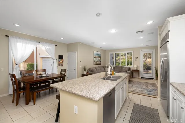 a kitchen with a stove a refrigerator and a dining table