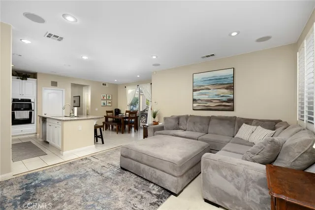 a living room with furniture and kitchen view