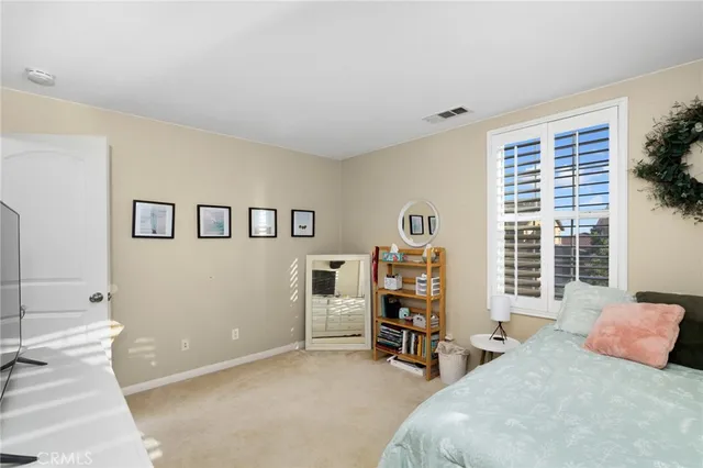 a bedroom with furniture and a window