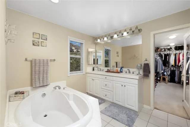 a spacious bathroom with a sink and a mirror