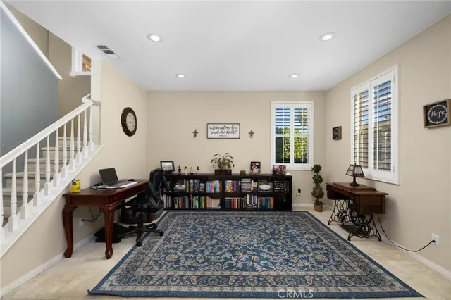 a view of a workspace with furniture and window