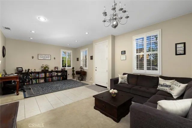 a living room with furniture potted plant and a window