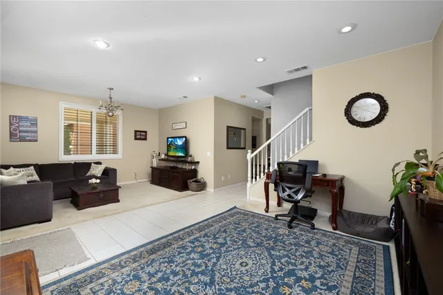 a living room with furniture rug and a window
