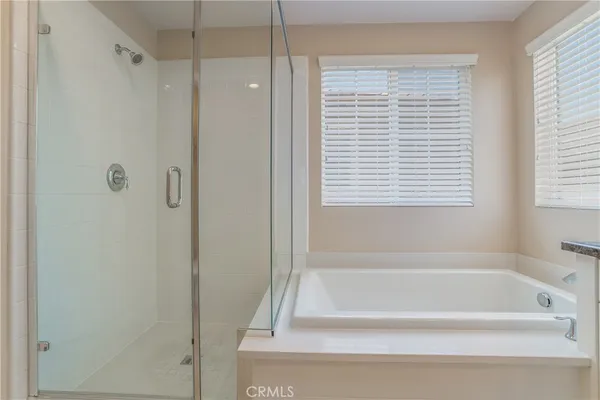 a bathroom with a bathtub next to a window