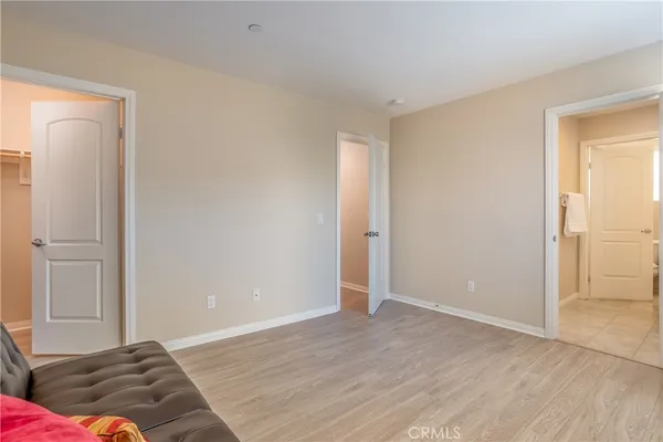 a living room with a couch and a walk in closet