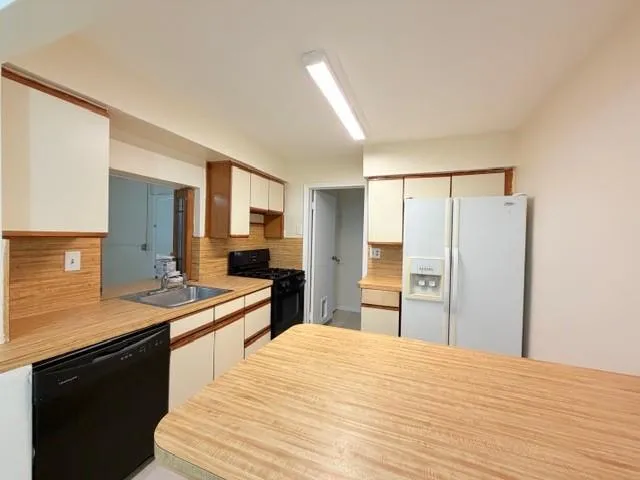 a view of a kitchen with a sink and a kitchen