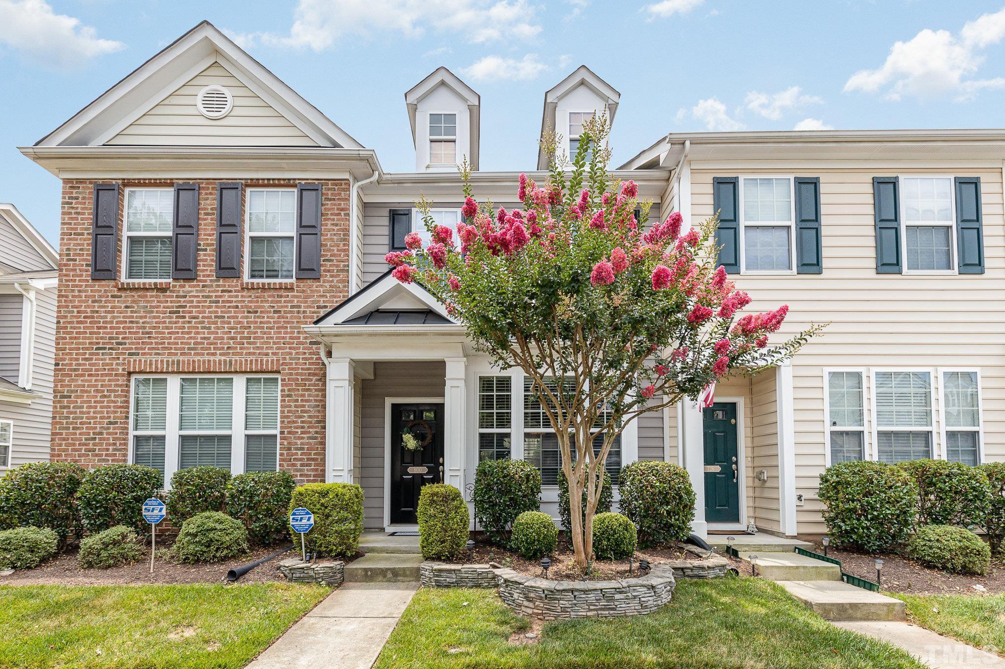 a front view of a house with yard porch and outdoor seating