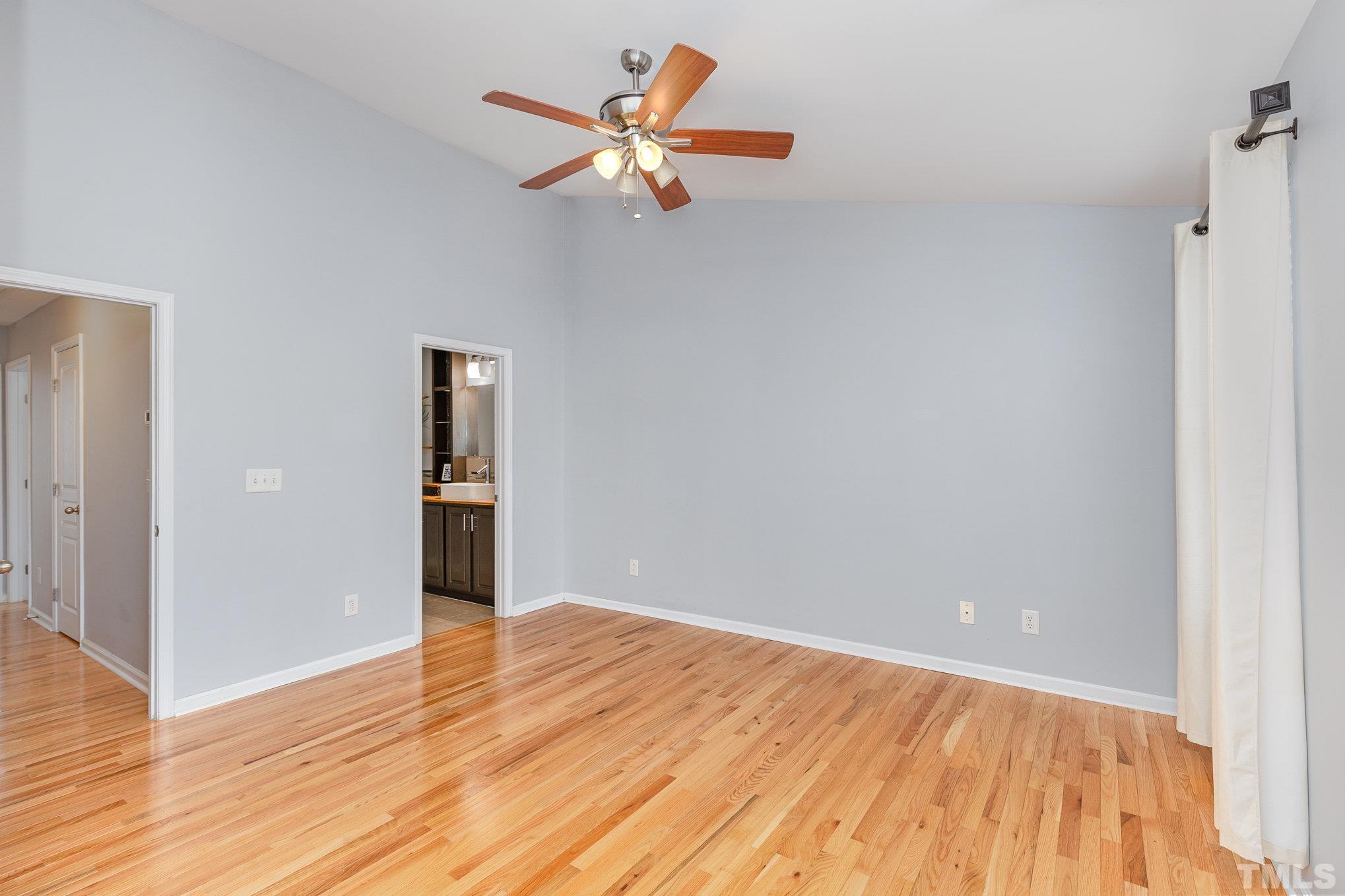 800 Bryant Street Raleigh, NC 27603 - Photo 12 of 20 a view of a room with wooden floor and a ceiling fan