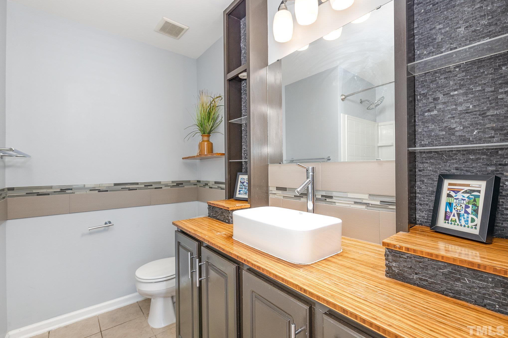 800 Bryant Street Raleigh, NC 27603 - Photo 13 of 20 a bathroom with a granite countertop sink mirror vanity and toilet