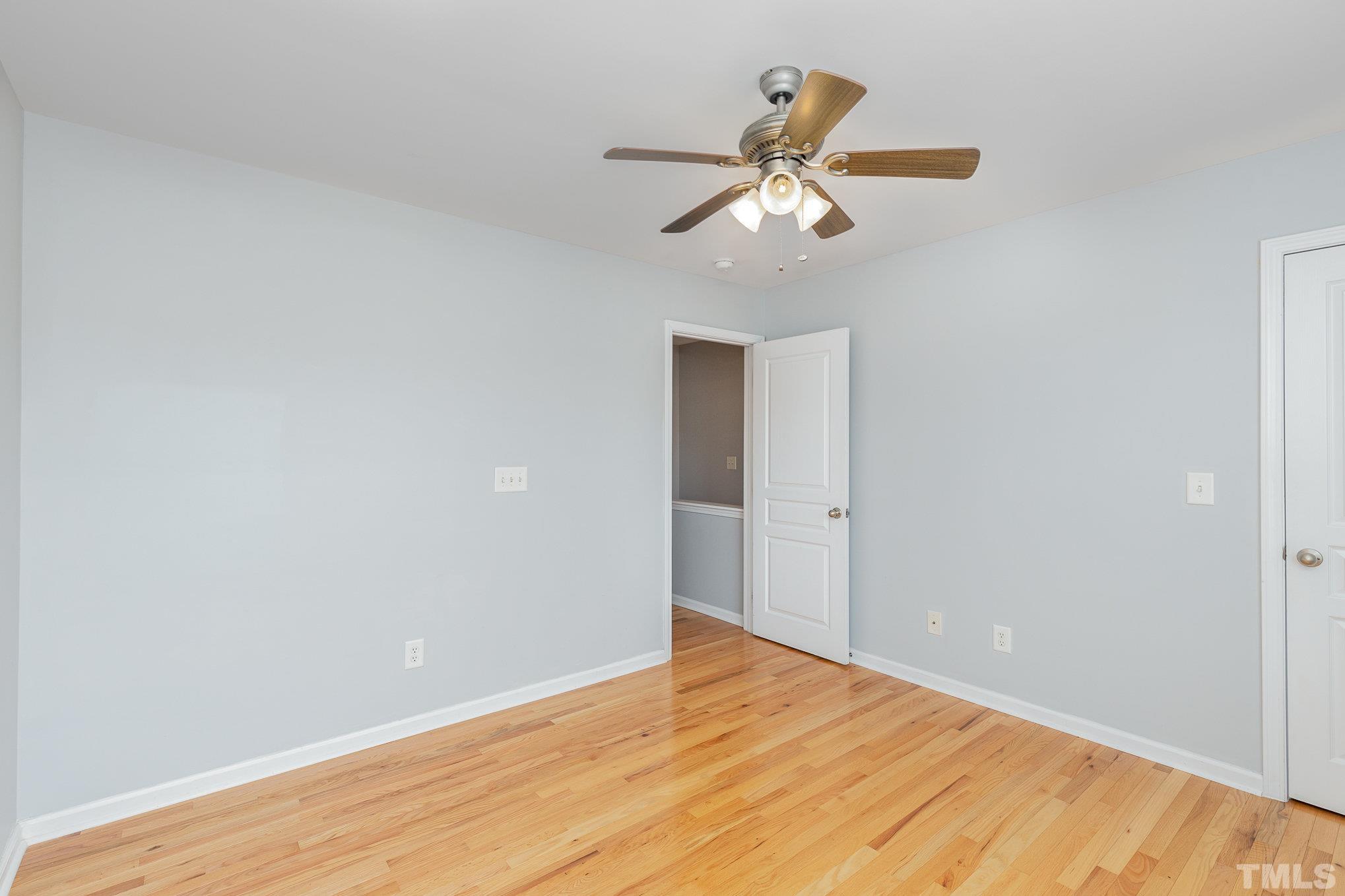 800 Bryant Street Raleigh, NC 27603 - Photo 15 of 20 a view of an empty room with wooden floor and a chandelier fan